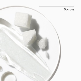 Clinique Liquid Facial Soap Mild Refill ingredient shot showing sucrose sugar cubes on a glass dish with clear gel texture