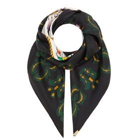 Essentiel Antwerp black silk scarf with green floral and gold chain print, styled in a diamond shape with pointed ends.