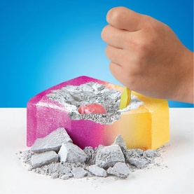 FAO Discovery dig-and-excavate toy in multi-colour pink and yellow blocks, with hand using tool to uncover hidden item within grey rubble