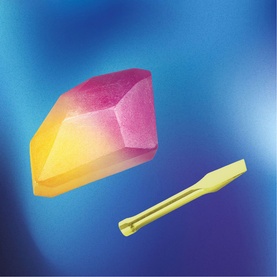FAO Discovery multi-coloured gem-shaped toy crystal in pink and yellow ombre, shown with small gold tweezers accessory
