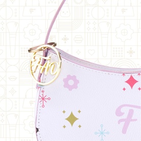 FAO Schwarz multi-coloured mini bag with gold logo charm, pastel pink and white design with star and floral print details