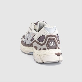 Asics Gel trainer in Cocoa Powder Pure Silver, rear view showing chunky cream sole, brown and grey panelled upper with GEL branding.