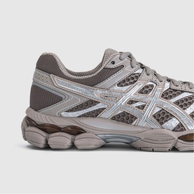 Asics gel-nimbus trainer in taupe and silver mesh with chunky white and grey sole, close-up side detail view