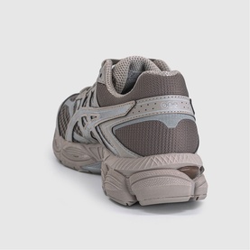 Taupe and grey chunky running trainer, rear three-quarter view showing mesh upper, overlaid panels, and ridged rubber sole