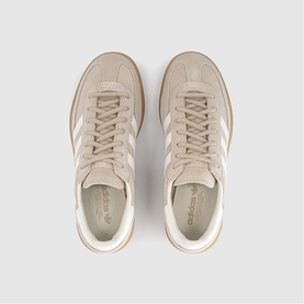 Adidas trainers in khaki and off-white suede with three white side stripes, lace-up fastening, and gum sole, top-down view