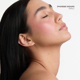 Model with Poco Beauty Universal Cream Stick in Bare It All, showing soft rosy blush on cheeks with a natural, dewy finish