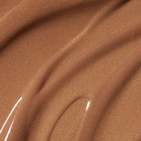 Poco Beauty sun care product texture swatch in warm bronze-brown tone, showing smooth creamy consistency
