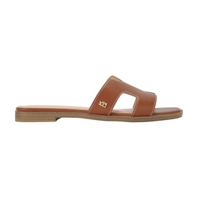 KG by Kurt Geiger beige leather flat mule sandal with H-strap cut-out design, gold logo detail, and tan rubber sole