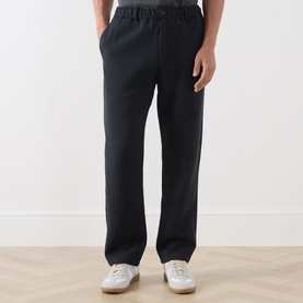 Model wearing Samsoe & Samsoe Jabari Casual Trousers in Dark Grey Mel, straight-leg fit with elasticated waist, styled with white trainers.