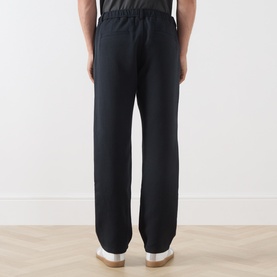 Model wearing Samsoe & Samsoe Jabari Casual Trousers in Dark Grey Mel, straight-leg fit with elasticated waist, rear view
