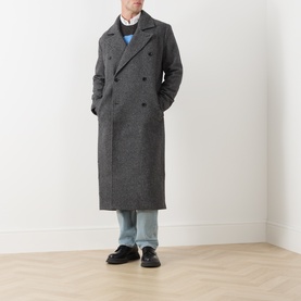 Model wearing Samsoe & Samsoe Dark Grey Mel wool double-breasted longline coat, styled with light blue jeans and blue sweatshirt.