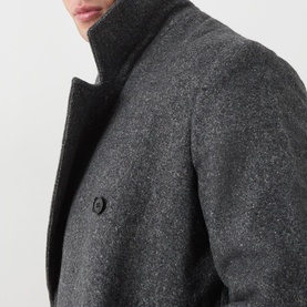 Model wearing Samsoe & Samsoe Dark Grey Mel wool coat, close-up of stand collar and button placket detail.
