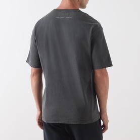 Model wearing Samsoe & Samsoe Black Lines crew neck T-shirt, back view, shown with dark shorts
