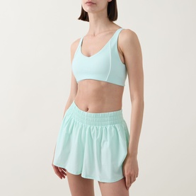 Model wearing Tala SkinLuxe Contrast Piping Sports Bra in Soft Mint with matching mint shorts