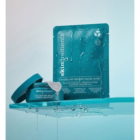 The Skin Nerd Eye-Light Eye-Bright Arbutin Under-Eye Pads and Skingredients Hydra-Hit Instant Facial Mask on a wet teal surface