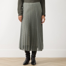 Model wearing Vince light green pleated midi skirt, styled with dark knit top and black leather boots