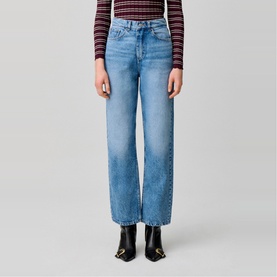 Model wearing Claude Pierlot Straight Leg Jeans in blue denim, faded finish, five-pocket style, styled with black ankle boots and striped top.