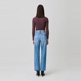 Model wearing Claude Pierlot Straight Leg Jeans in blue denim, faded wash, five-pocket style, styled with a striped long-sleeve top and black heeled