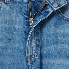 Claude Pierlot Straight Leg Jeans in blue denim, close-up of silver zip fastening and silver rivets on faded cotton denim