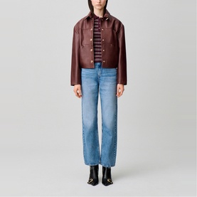 Model wearing Claude Pierlot Straight Leg Jeans in blue denim, faded finish, styled with a burgundy leather jacket and striped top.