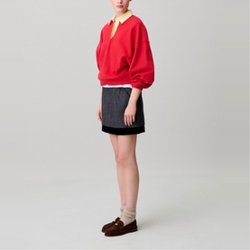 Model wearing Claude Pierlot Womens French Dress in black mini skirt style, styled with red polo sweatshirt and brown loafers