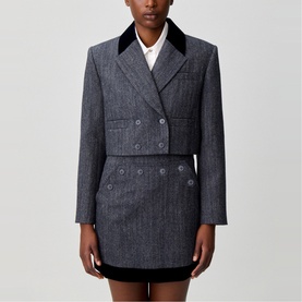 Model wearing Claude Pierlot black herringbone double-breasted blazer dress with velvet collar and contrast hem detail.