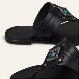Bash black leather flat sandals with silver-tone studs and turquoise stone embellishment on toe strap, close-up detail shot