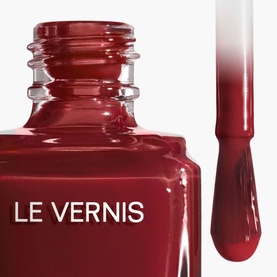 Chanel Le Vernis nail varnish in 421 Cristalline, deep red shade, shown with brush applicator displaying rich colour payoff