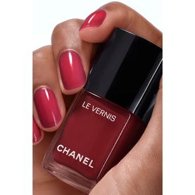 Chanel Le Vernis nail varnish in 421 Cristalline, deep berry-red shade, shown in bottle with matching manicured nails
