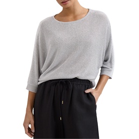 Model wearing light grey knit batwing-sleeve sweater with scoop neck, styled with black wide-leg trousers
