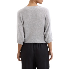 Model wearing a grey marl knit top with dolman sleeves and V-back neckline, styled with black wide-leg trousers