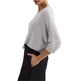 Model wearing light grey knit sweater with 3/4 sleeves and relaxed fit, styled with black drawstring trousers