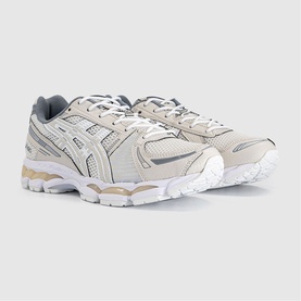 Asics Gel-Kayano trainers in cream and smoke grey, featuring mesh upper, silver branding, and chunky white sole