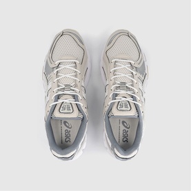 Asics trainers in cream and smoke grey, overhead flat lay showing mesh upper, silver branding and white lacing detail