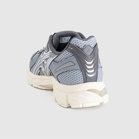 Asics trainer in Piedmont Grey Gravel, rear three-quarter view showing mesh upper, silver logo detail and chunky cream midsole.