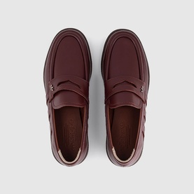 Adidas penny loafers in fox brown dark brown leather, overhead view showing moc-toe stitching and slip-on silhouette
