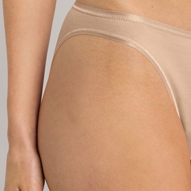 Model wearing Hanro beige brief, close-up side view showing smooth fabric and elasticated waistband