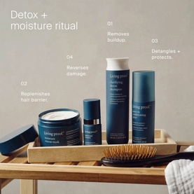 Living Proof Detox and Moisture Ritual haircare set including shampoo, treatment, serum, and brush displayed on a wooden tray