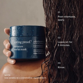 Living Proof Moisture Rescue Mask deep blue jar held by model, with usage steps: apply post-shampoo, leave 5 minutes, rinse.