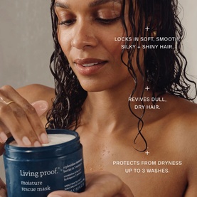 Model with Living Proof Moisture Rescue Mask hair treatment jar, wet hair styled to show hydration benefits