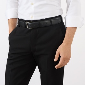 Model wearing Prada Gabardine Tailored Trousers in black, slim-leg with pressed crease and belt loops, styled with a black leather belt and white