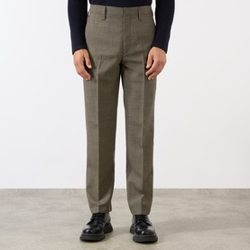 Model wearing Prada Houndstooth Check Trousers in military, slim-leg with constructed waistband, styled with navy knit and black leather shoes.