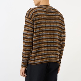 Model wearing Prada rust striped wool crew neck jumper, rear view showing horizontal multicolour stripe pattern and long sleeves