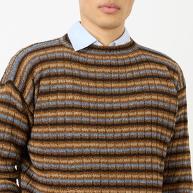 Model wearing Prada rust striped wool crew neck jumper, styled with a light blue collared shirt underneath