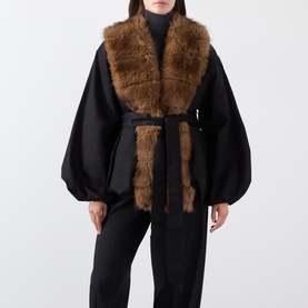 Model wearing Rotate black jacket with brown faux fur collar and front panel, belted waist, oversized balloon sleeves, styled with black trousers