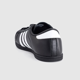 Adidas trainer in black and white, leather upper with three white stripes, black rubber sole, rear angle view.
