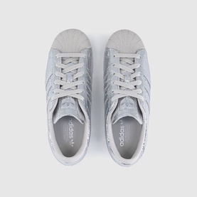 Adidas Superstar trainers in silver metallic, textured glitter upper, shell toe, white lace-up front, top-down view