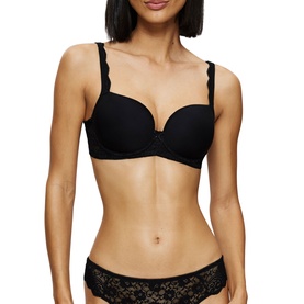 Model wearing Triumph black full cup bra with scalloped lace trim straps, styled with matching black lace briefs