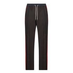 Wales Bonner Energy Logo Track Pants in brown/black, straight-leg with red contrast side stripes, elasticated drawcord waistband, pressed pleats