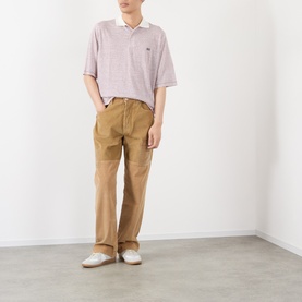Model wearing Wales Bonner polo in Ivory/Wine with tan chinos and white loafers